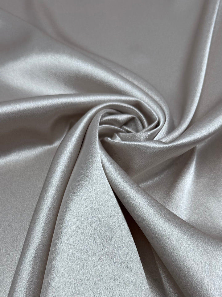 Super Cheap Fabrics’ Satin Back Crepe in Crystal Gray (150cm) features a smooth, lustrous surface that drapes beautifully, ideal for elegant tops or chic eveningwear.