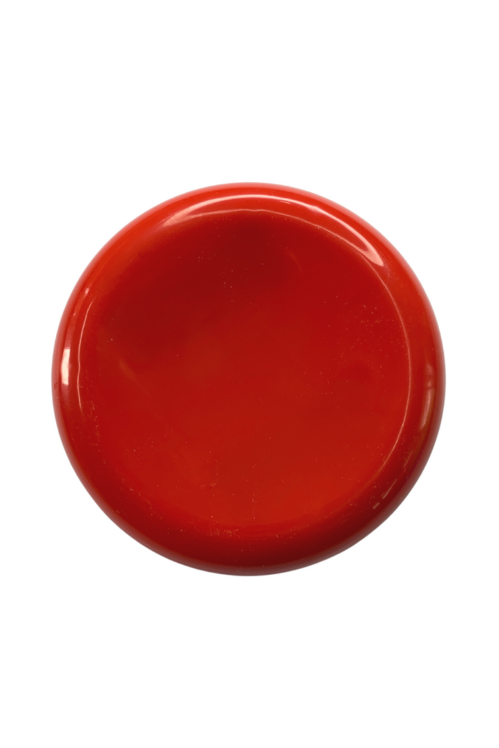 A round, solid red Magnetic Pin Holder by Super Cheap Fabrics with a smooth surface is centered against a white background. The pin holder has a glossy finish and a slightly curved edge, perfectly designed for your organizational needs.