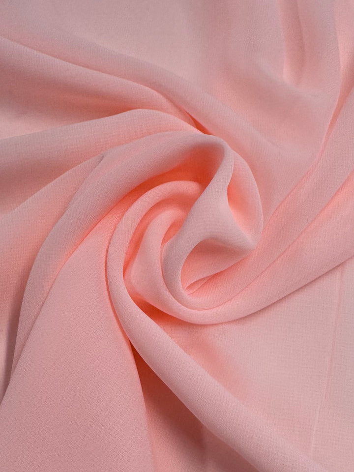 Hi-Multi Chiffon - Baby Pink - 148cm by Super Cheap Fabrics is a light, semi-sheer fabric with gentle folds and a smooth, delicate texture, perfect for an airy, elegant look.