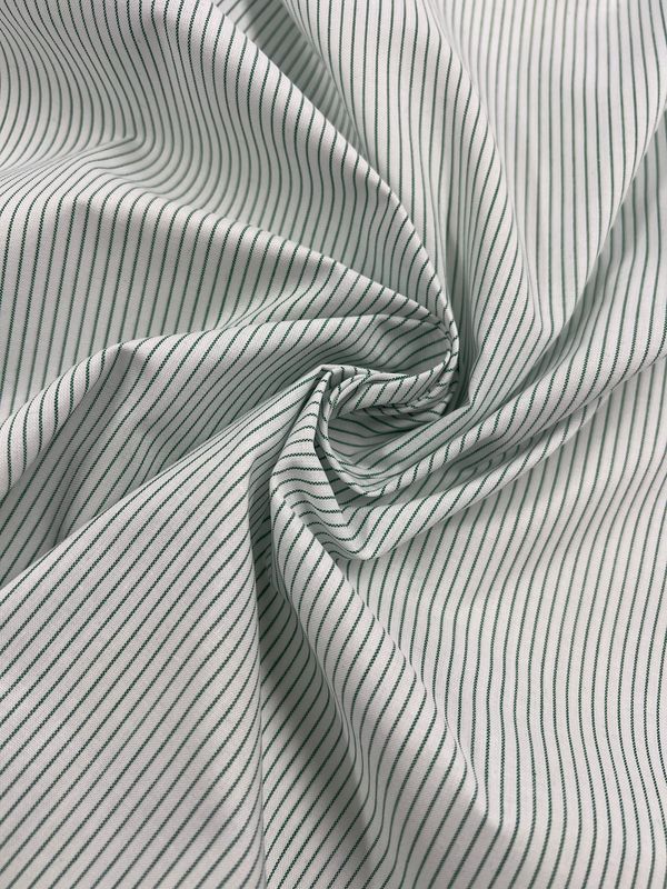 Close-up of the Shirting - Harp - 145cm fabric by Super Cheap Fabrics, featuring lightweight polyester cotton with evenly spaced white and black pinstripes, twisted into a spiral pattern. The design adds texture and a sense of movement to the image, making this versatile material ideal for multiuse applications.