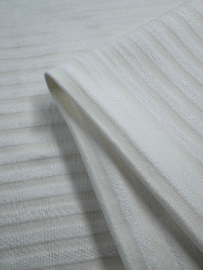 Close-up of Super Cheap Fabrics’ Unbrushed Fleece - Ripple Ivory (158cm), featuring ultra soft, light gray ribbed texture with horizontal stripes. Crafted from high-quality cotton, it’s stretchy and ideal for clothing or upholstery projects.