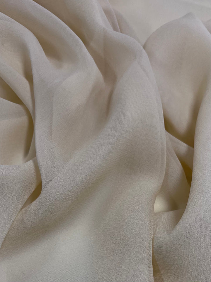 The Pure Silk Georgette - Gold from Super Cheap Fabrics offers a lightweight, flowing texture with gentle folds and antique gold hues, showcasing its fine, elegant quality. Width: 135cm.