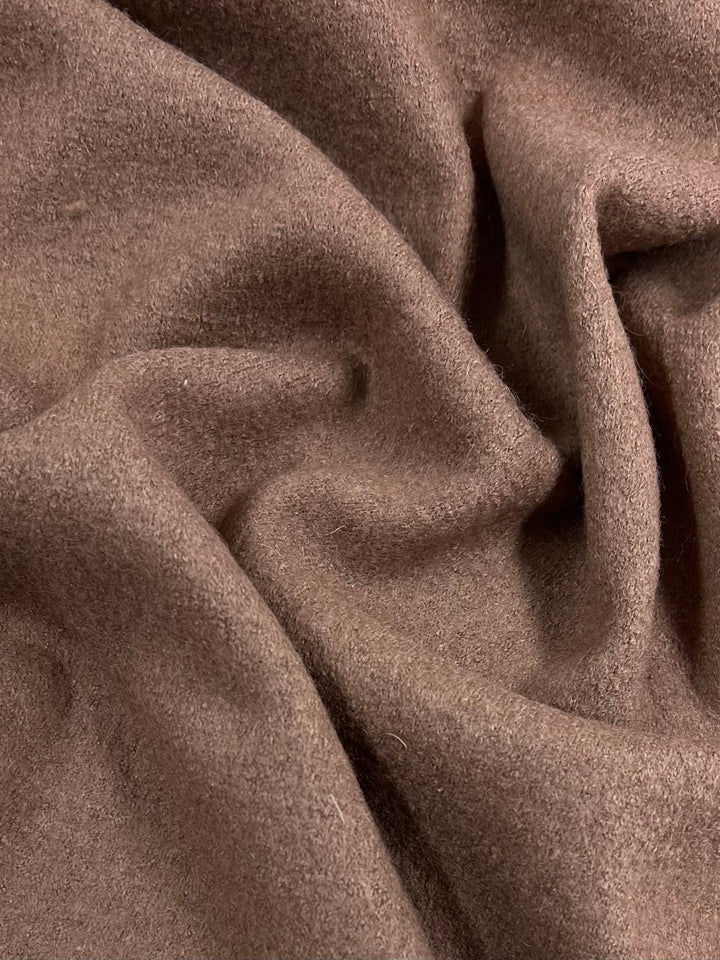 Close-up of a piece of Boiled Wool - Burlwood - 150cm fabric by Super Cheap Fabrics with a slightly fuzzy texture, showing gentle folds and creases. The heavy-weight fabric appears to be a cozy, warm material, ideal for autumn/winter clothing.