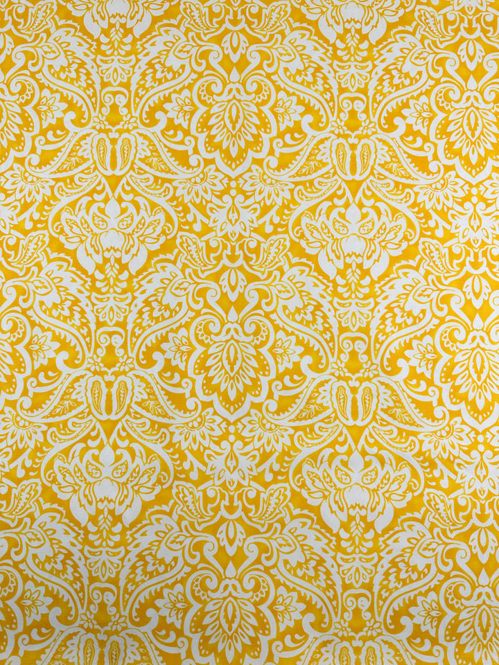 A detailed, ornate pattern featuring a symmetrical floral and paisley design in bright yellow on a white cotton fabric background. Perfect for home décor or fashion accessories, the intricate motif includes leaves, flowers, and swirling shapes, creating a vibrant and decorative aesthetic. This is the Printed Duck Canvas - Damask - 145cm by Super Cheap Fabrics.