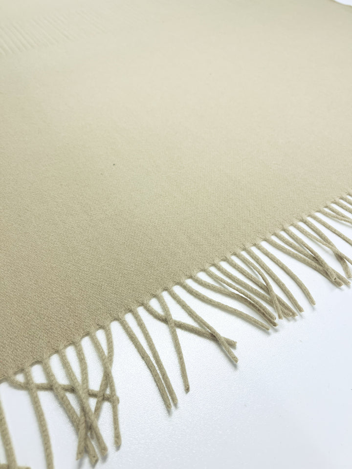 A close-up of a Merino Wool Pale Olive Green fabric panel with neatly arranged fringes along one edge, set against a white background. Product: Super Cheap Fabrics.