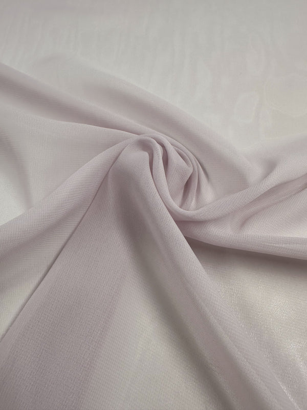 A close-up of Super Cheap Fabrics' Hi-Multi Chiffon - Calcite - 145cm shows it draped smoothly into a spiral, its soft and sheer texture perfect for floaty tops, elegantly set against a plain background.