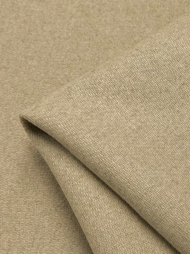 A close-up of a folded piece of Reversible Merino Wool - Latte - 150cm fabric with a subtle, small-scale herringbone pattern. The fabric, made from Merino wool, appears to have a soft texture and a slight sheen, promising breathability and moisture-wicking properties. This high-quality fabric is offered by Super Cheap Fabrics.