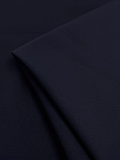 A close-up of Super Cheap Fabrics’ Plain Lycra in black (165cm), neatly folded to reveal its smooth, soft texture—ideal for activewear and swimwear.