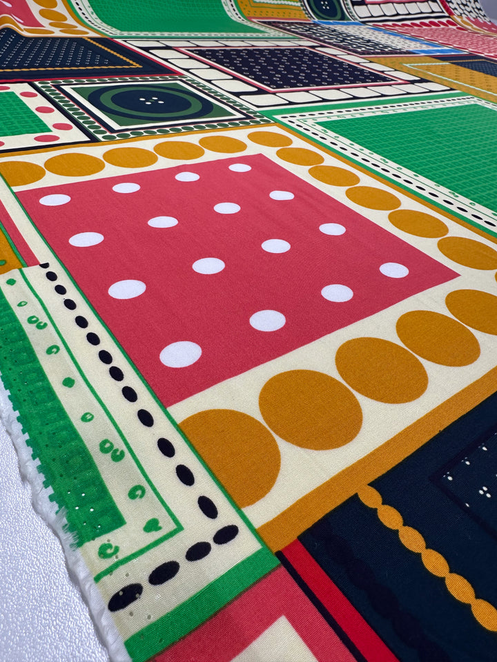 Designer Rayon - Stile by Super Cheap Fabrics (145cm) showcases bold abstract prints with red polka-dot squares, yellow circles, green rectangles, and black-and-white dotted lines for a vibrant geometric look.