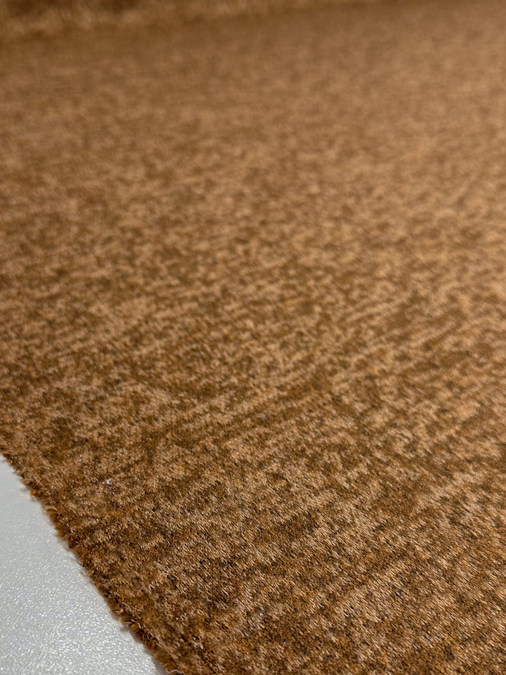 Close-up of Super Cheap Fabrics' Textured Knit - Foxtrot (155cm) in brown, showing its soft, slightly fuzzy surface and detailed fibers. The medium weight knit fabric’s cozy texture and subtle shading are clearly visible.