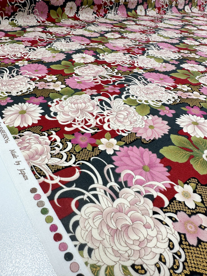 A close-up of Japanese Printed Cotton - Chrysanthemum by Super Cheap Fabrics shows detailed floral and Japanese motifs in pink, white, green, and gold on a black and red background with a printed edge marked "Made by Japan." Width: 112cm.