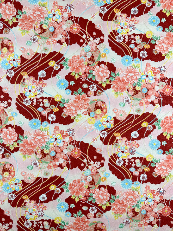 Super Cheap Fabrics’ Japanese Printed Cotton - Textured Crane Garden (112cm) features peonies, daisies, cherry blossoms in red, pink, and cream with maroon clouds and gold lines for a classic Japanese look.
