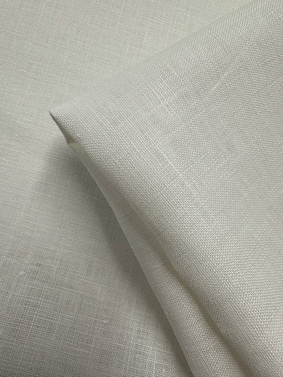 A close-up of Super Cheap Fabrics' Pure Linen - Off White 02 (140cm), showing its fine threads, breathable texture, and soft, natural finish.