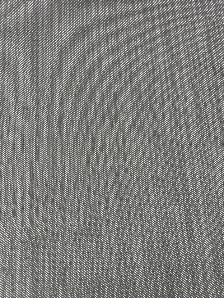 Close-up image of a grey woven fabric with a subtle striped pattern, perfect for furniture upholstery. The texture shows fine, evenly spaced horizontal lines, creating a soft and uniform appearance in this durable fabric. Upholstery Twill - Dove Grey - 147cm by Super Cheap Fabrics.