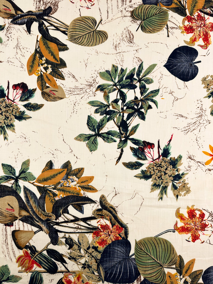 The Super Cheap Fabrics Printed Linen Blend - Botanic Sketch (148cm) features a lightweight cream base with a scattered multicolour green, yellow, orange, and black botanical pattern—ideal for summer jackets.