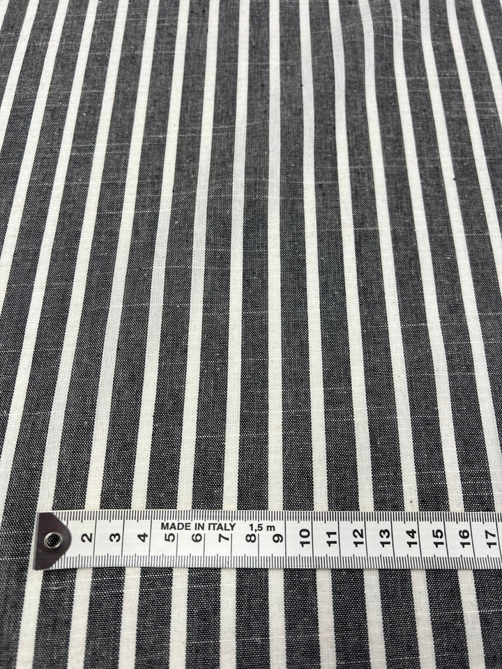 A close-up of Super Cheap Fabrics' Linen Cotton - Dark Gray Stripe - 145cm with a measuring tape placed at the bottom, showing lengths in centimeters from 0 to 17. The tape is marked with "MADE IN ITALY," highlighting the premium quality of this breathable fabric crafted from natural fibers.