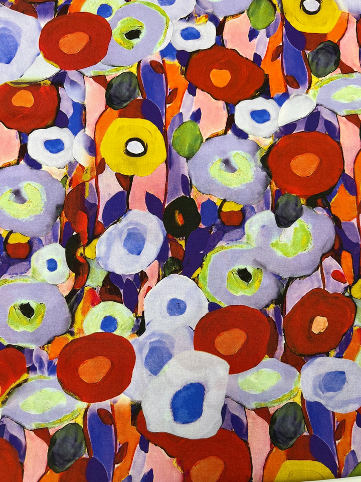 A vibrant abstract painting featuring a variety of colorful, round shapes and organic forms. The colors include shades of red, blue, green, purple, and yellow, all layered over a pink background with brushstroke patterns reminiscent of Designer Rayon - Poppy Fields - 145cm by Super Cheap Fabrics. The overall composition is dynamic and lively.