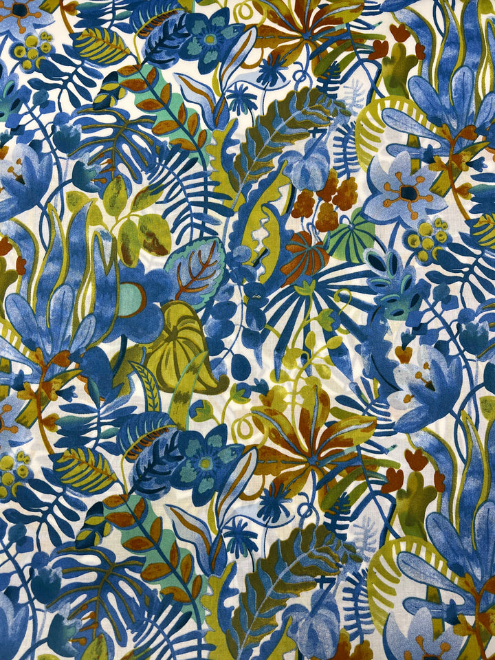A vibrant Printed Cotton - Aquatic Flora - 148cm by Super Cheap Fabrics featuring an array of abstract blue and green leafy plants, flowers, and foliage interspersed with touches of yellow and brown. The design creates a dense, jungle-like appearance with various shapes and textures blending together harmoniously.