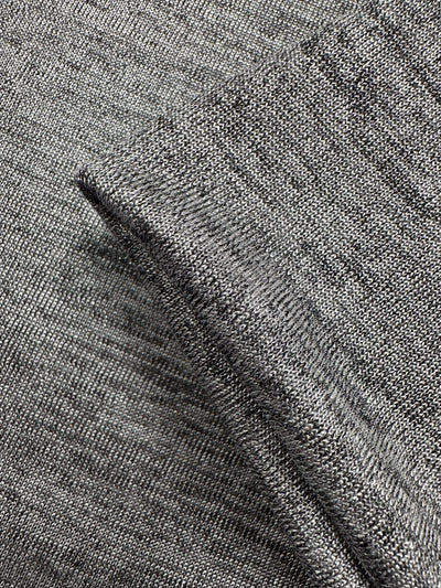 Close-up of Super Cheap Fabrics' Textured Knit - Greyline Lamé (145cm): two gray knit pieces, one partially folded over the other, showcasing the weave pattern and subtle metallic sheen.