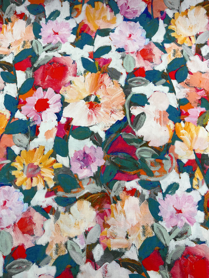 A vibrant, dense floral pattern on soft rayon fabric features an array of colorful flowers in shades of red, pink, orange, yellow, and white. The flowers are surrounded by green leaves, creating a lively and energetic composition that's perfect for versatile choices in fashion. Introducing the Designer Rayon - Botanical - 145cm from Super Cheap Fabrics!