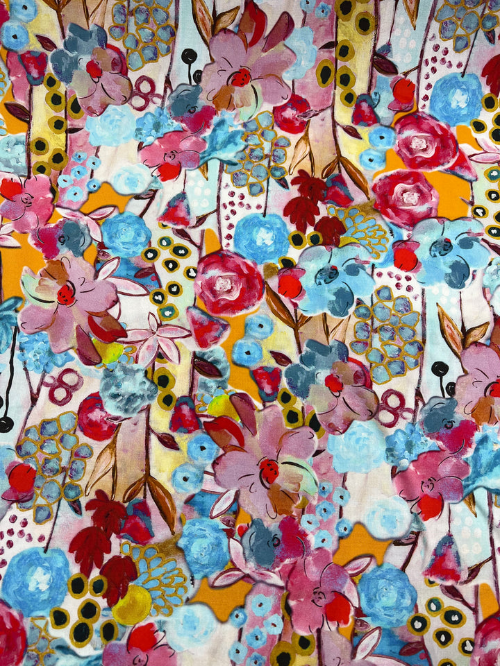 A vibrant and colorful floral pattern featuring large pink, blue, and red flowers with green leaves. The background includes abstract shapes in yellow and white with black dots and lines, creating a lively and dynamic design. This versatile fabric is perfect for those who love vibrant prints in Designer Rayon - Impressionist - 145cm by Super Cheap Fabrics.