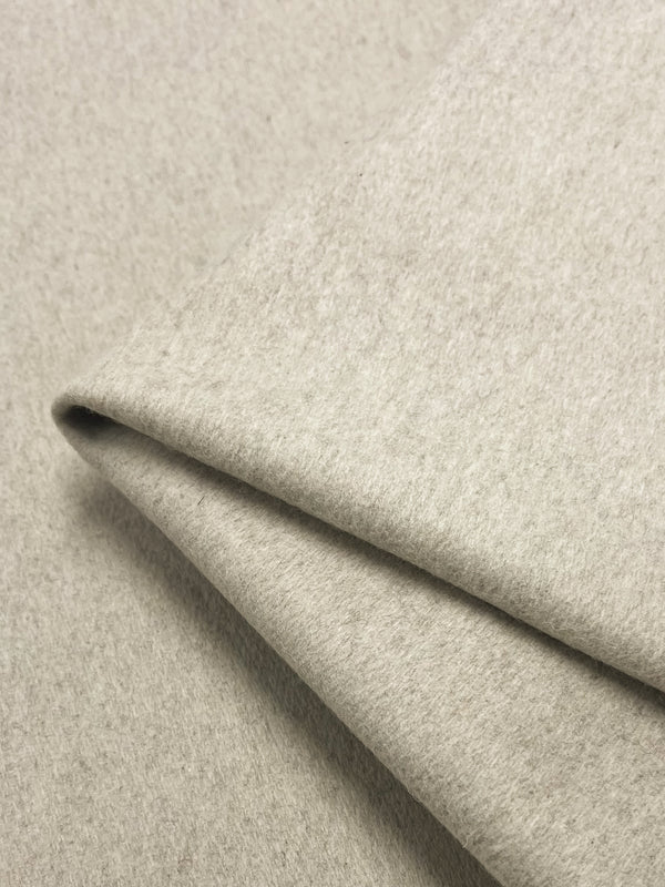 Close-up of a neatly folded piece of Wool Cashmere - Ancient Scroll - 150cm by Super Cheap Fabrics. The material has a smooth texture and appears soft and lightweight, with a slight sheen visible on the surface.