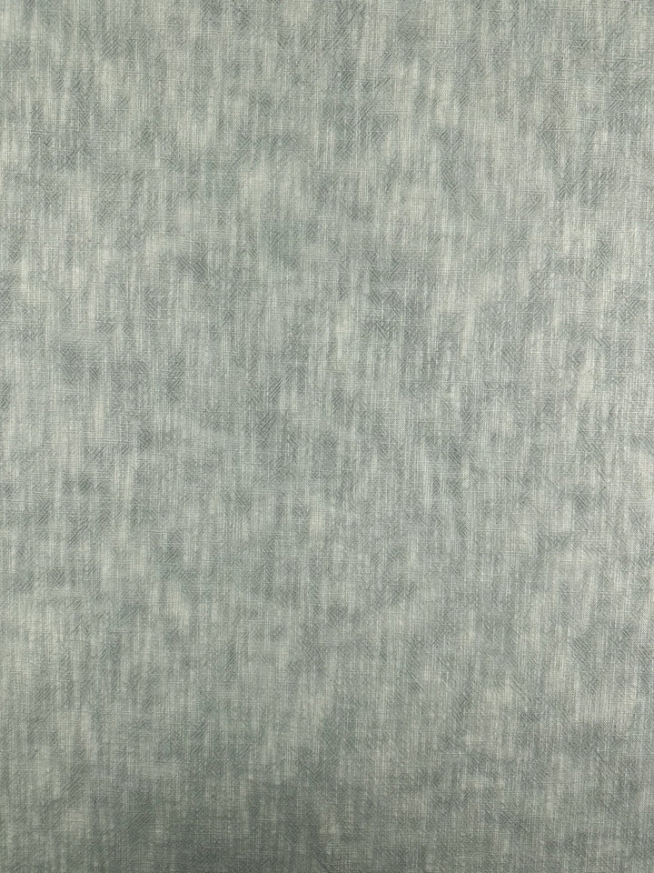 The Basket Dyed Cotton - Sea Mist from Super Cheap Fabrics features a textured surface with a soft, mottled pattern in various shades of gray. Its appearance is uniform, similar to heavyweight cotton fabric or brushed metal.