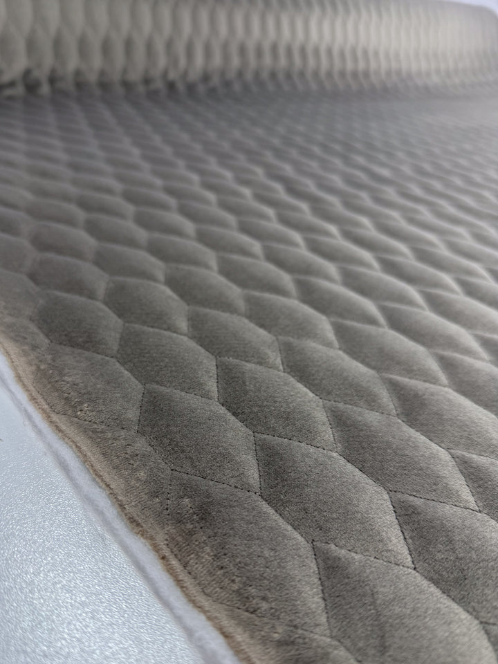 Close-up of Super Cheap Fabrics’ Quilted Velvet in Vintage Khaki (145cm) shows a soft, plush diamond pattern—perfect for upholstery or designer deadstock projects.