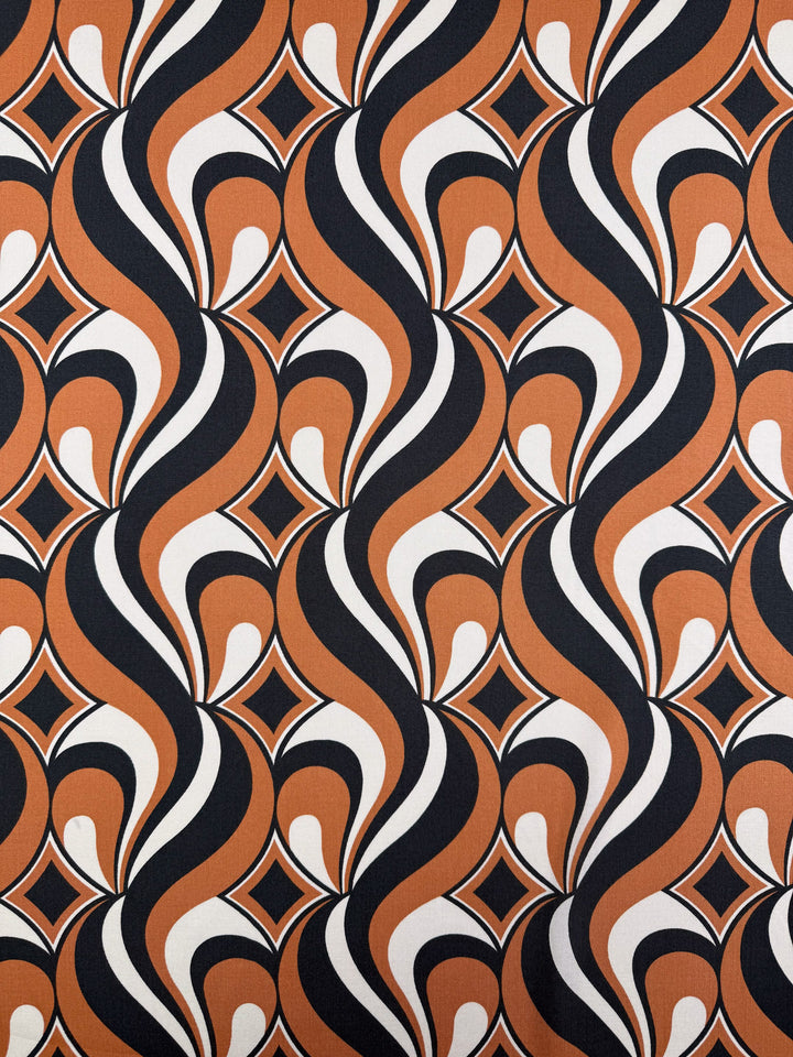 Designer Rayon - Retro Swirl by Super Cheap Fabrics features a bold 1970s-inspired geometric pattern with wavy black, white, and orange shapes plus diamond motifs. Width: 142cm. Perfect for vibrant, retro-style creations.