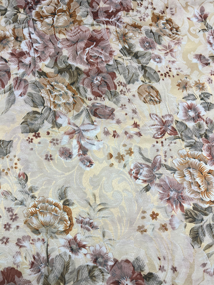 The Designer Brocade - Vintage - 150cm by Super Cheap Fabrics showcases a beautiful floral brocade pattern, with large, intricate flowers in brown, pink, and green shades on a light beige background. The design incorporates leaves and smaller blossoms, exuding an elegant and vintage charm that echoes Italy's timeless artistry. This medium-weight fabric offers versatile use.