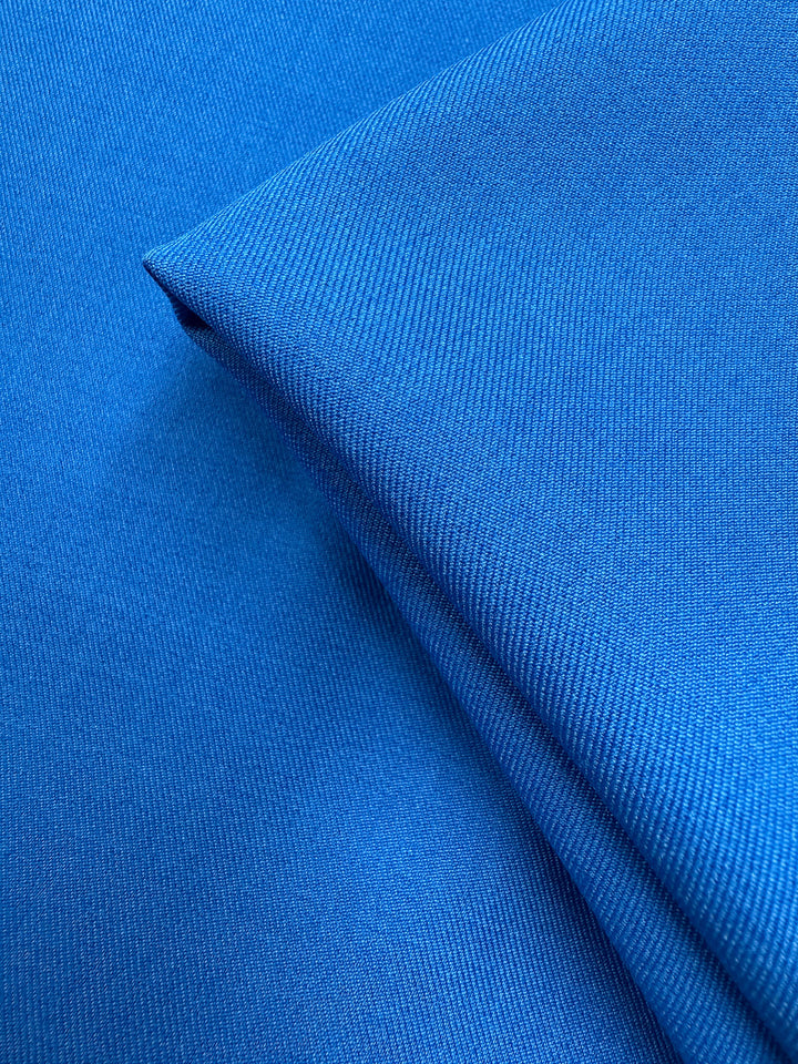 Two pieces of Super Cheap Fabrics' Liquid Twill - French Blue (150cm) are stacked, showing smooth, fine texture and clean lines with vibrant, even color.