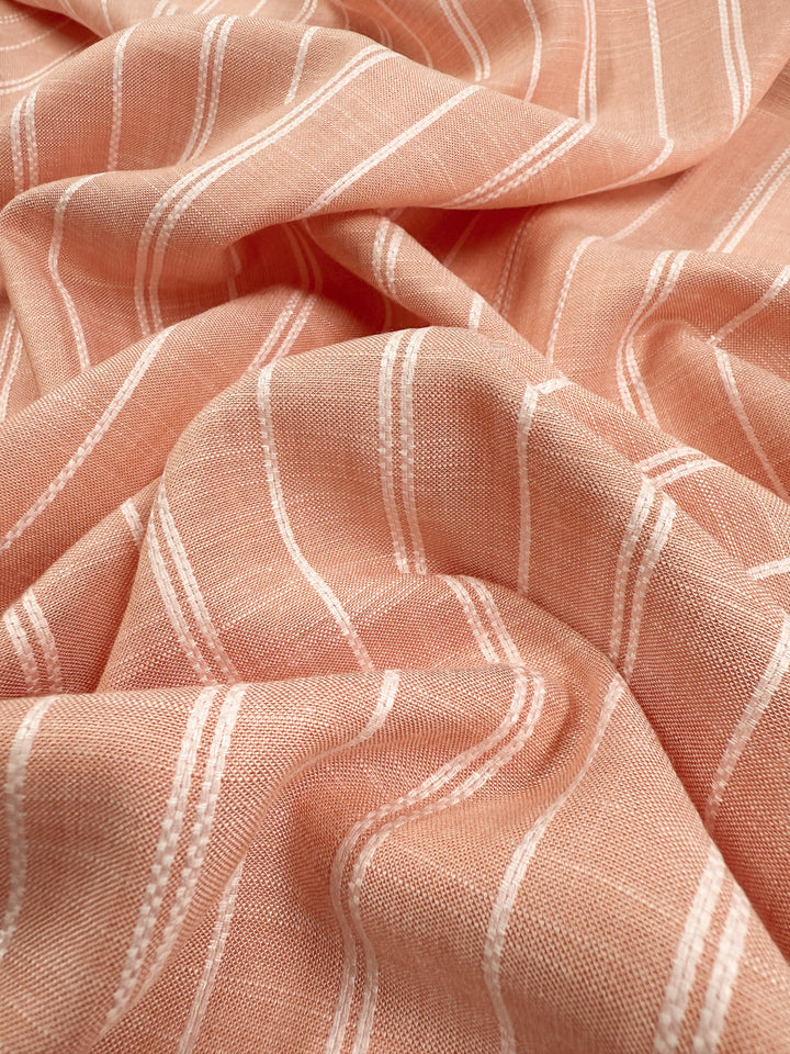 A close-up of Super Cheap Fabrics’ Linen Blend - Dusty Blush Ticking (142cm) highlights its soft, textured pink fabric with white, evenly spaced horizontal stripes and gentle folds.