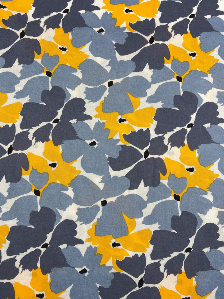 The Designer Rayon - Summer by Super Cheap Fabrics features an abstract print with overlapping floral shapes in blue, grey, yellow, and black. Its vibrant and modern style on Rayon fabric makes it a versatile choice for any decor or fashion piece. Width: 140cm.