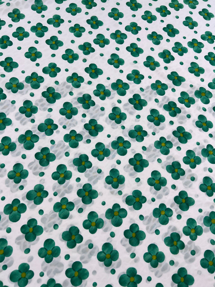 The Salt Shrunk Print - Clover by Super Cheap Fabrics features a vibrant pattern of green and yellow flowers arranged on a white background, creating an evenly spaced, repetitive design across the 155cm wide fabric.