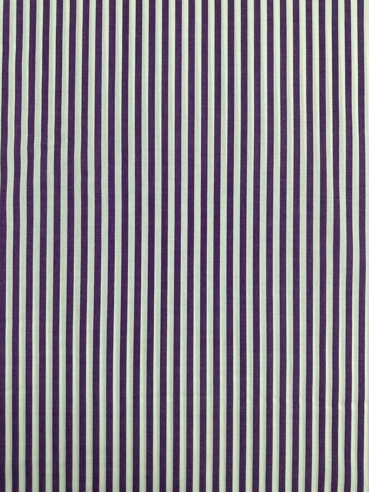 A rectangular pattern in 100% cotton featuring alternating vertical stripes in purple and white. The lightweight fabric ensures comfort, with the evenly spaced stripes running from top to bottom providing a clear contrast. This Cotton Lawn - Purple Stripe - 150cm by Super Cheap Fabrics is perfect for any sewing project requiring both style and breathability.