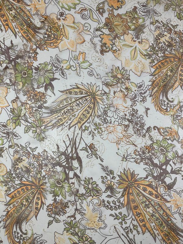 The Pure Printed Silk - Jaipur by Super Cheap Fabrics showcases a detailed floral pattern featuring green, yellow, and brown flowers and leaves on a light background. This intricate design is printed on lightweight silk fabric measuring 130cm in width, featuring various shapes and sizes of blooms, including large stylized flowers and smaller delicate foliage intertwined.