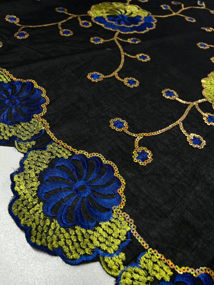 Embroidered Sequins - Clusters - 130cm by Super Cheap Fabrics featuring intricate blue and green floral patterns. The design includes large blue flowers with green accents, connected by delicate gold stems and smaller flowers. The black fabric, 130cm in width, provides a striking contrast to the multi-colour embroidery.