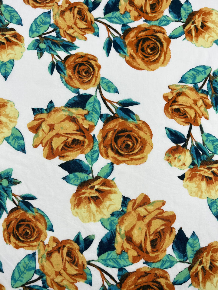 An intricate pattern featuring yellow roses with green leaves on a white background. The roses are detailed and vary slightly in size, creating a lush and vibrant floral design on this light weight fabric, the **Printed Rayon - La Flora - 145cm** from **Super Cheap Fabrics**, made from 100% Rayon.